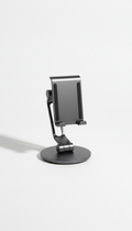 A centered frontal view of an adjustable phone stand on a 'Pure White' background. The lighting is soft, creating a shadow...