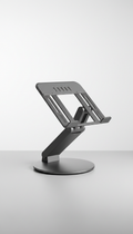 An ergonomic laptop stand is perfectly centered in the frame against a clean, minimalistic background. The stand is...