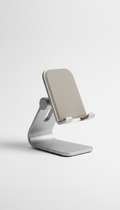 A desktop phone stand, designed for ergonomic comfort, stands centered on a smooth, the lighting is soft and diffused,...